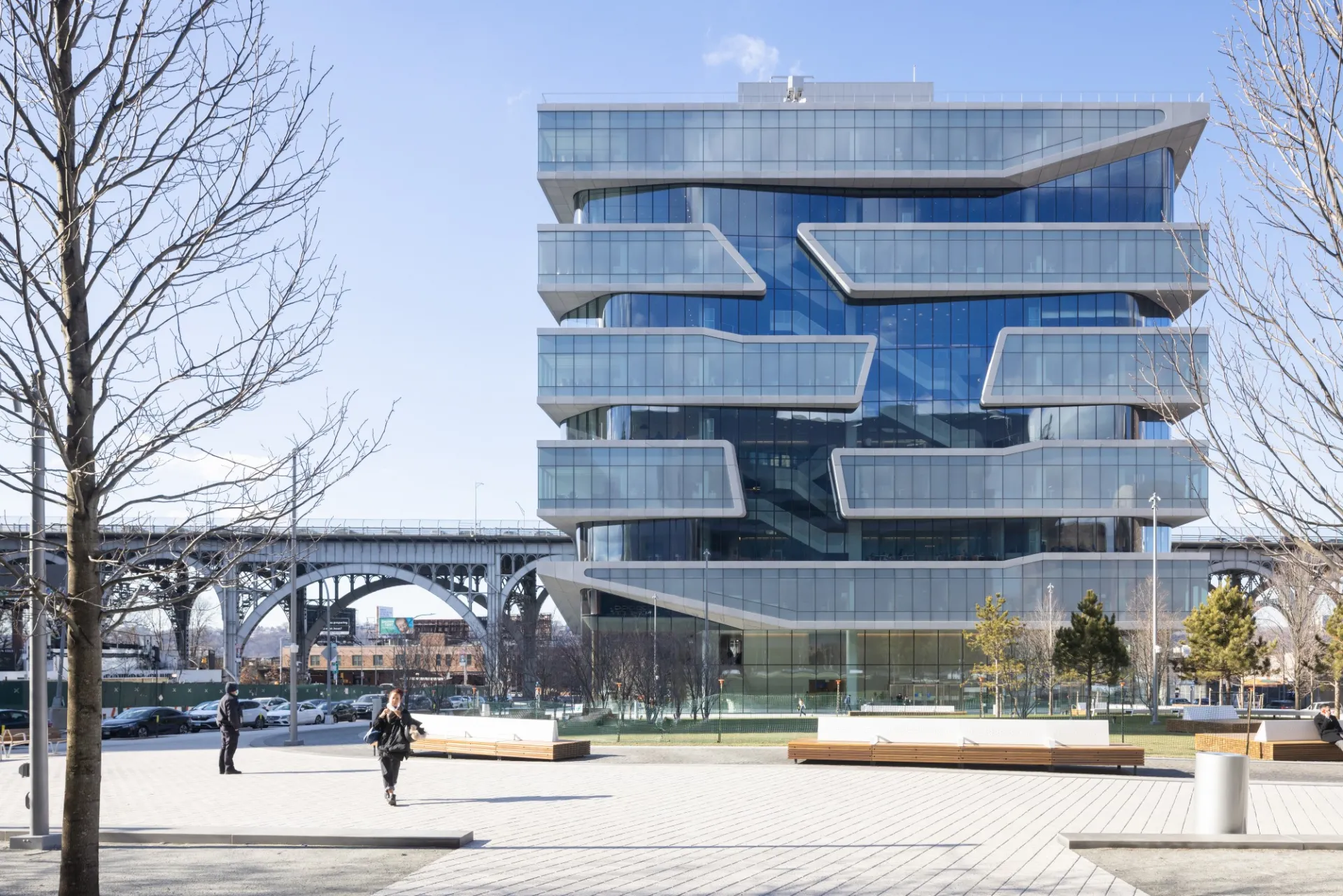 A view of Henry R. Kravis Hall and The Square at Columbia's Manhattanville campus with the Viaduct in the background.