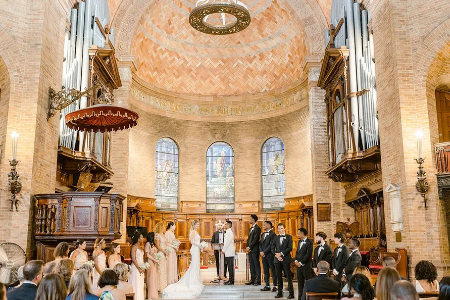 A wedding ceremony being held at St. Paul's Chapel at Columbia University. 
