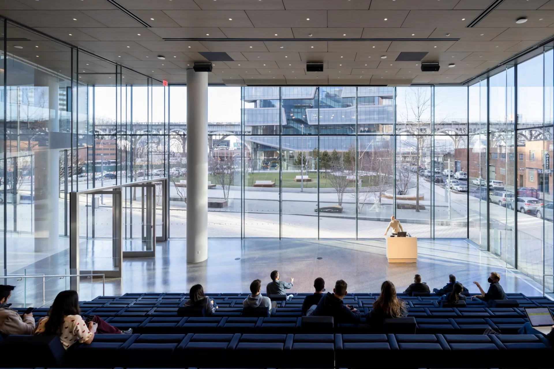 The interior of a large lecture hall within David Geffen Hall overlooks Henry R. Kravis Hall. 