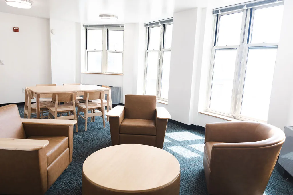 A refreshed lounge in Broadway Hall with new paint, flooring, lighting, and furniture.