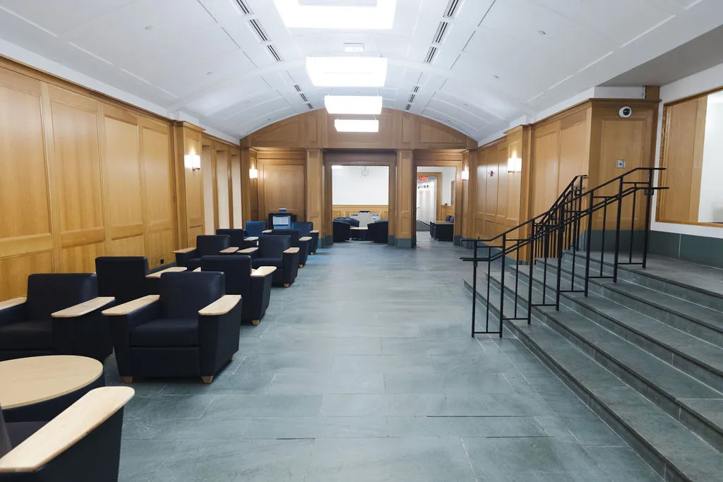 The first floor lobby in Broadway Hall with new flooring and blue furniture.
