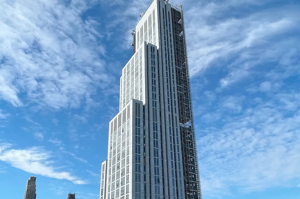 A view of the upper floors of 600 W. 125th Street on a partly cloudy day.