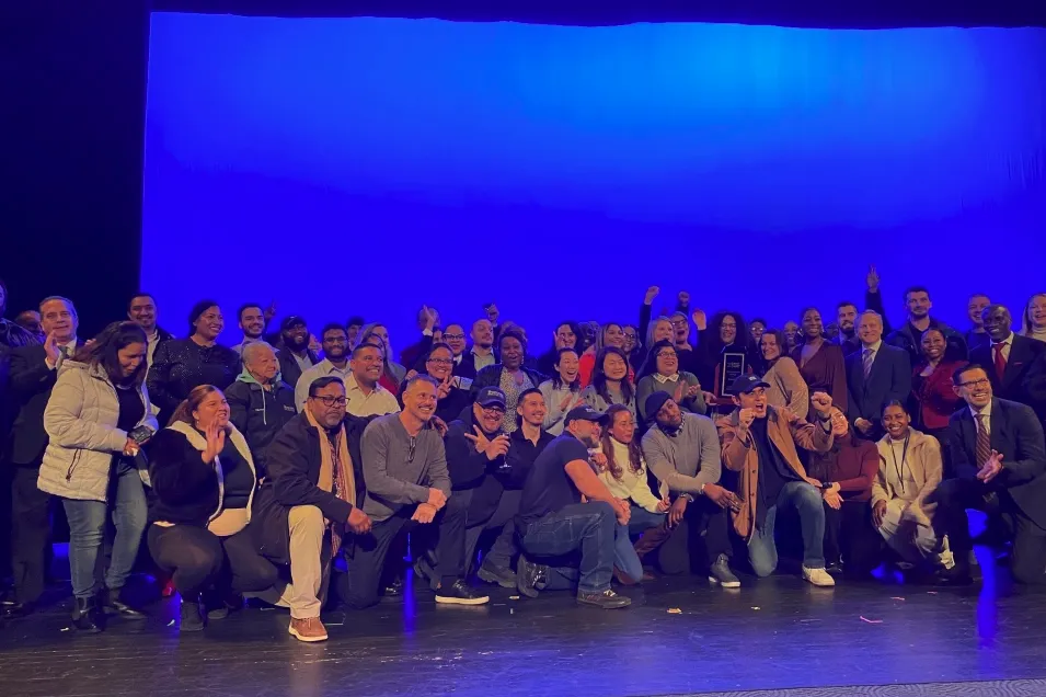 Members of Columbia Residential gather on the stage in the Lerner auditorium after winning the first Facilities and Operations PRIDE Award.