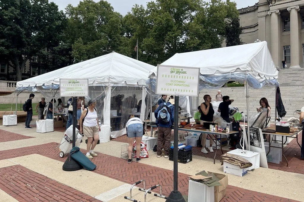 People look through donated items in white tents set up on Low Plaza.
