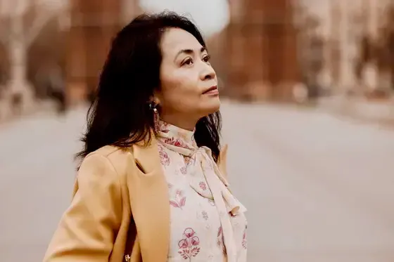 Maria Bootsma stands on a street and looks in the distance.